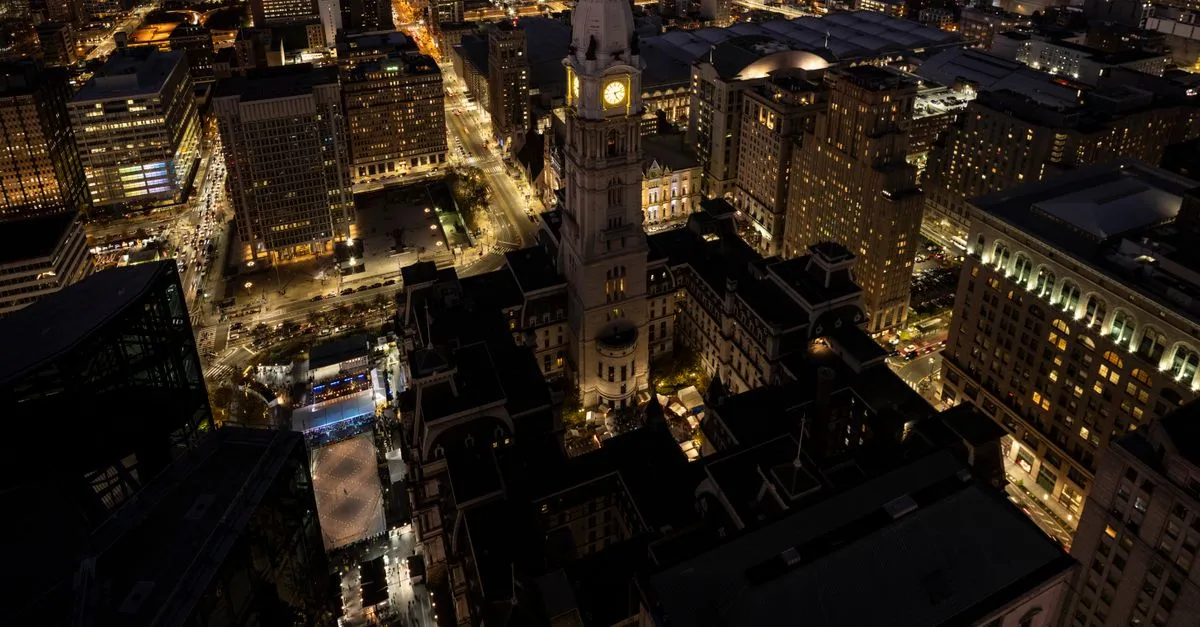 Philadelphia City Hall illuminated at night in the center of downtown Philadelphia.