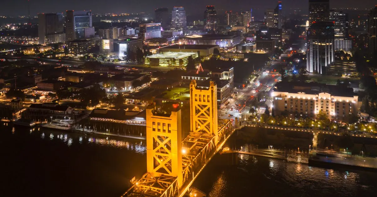 The illuminated Tower Bridge over the Sacramento River at night, the historic waterfront that connects downtown Sacramento to West Sacramento.