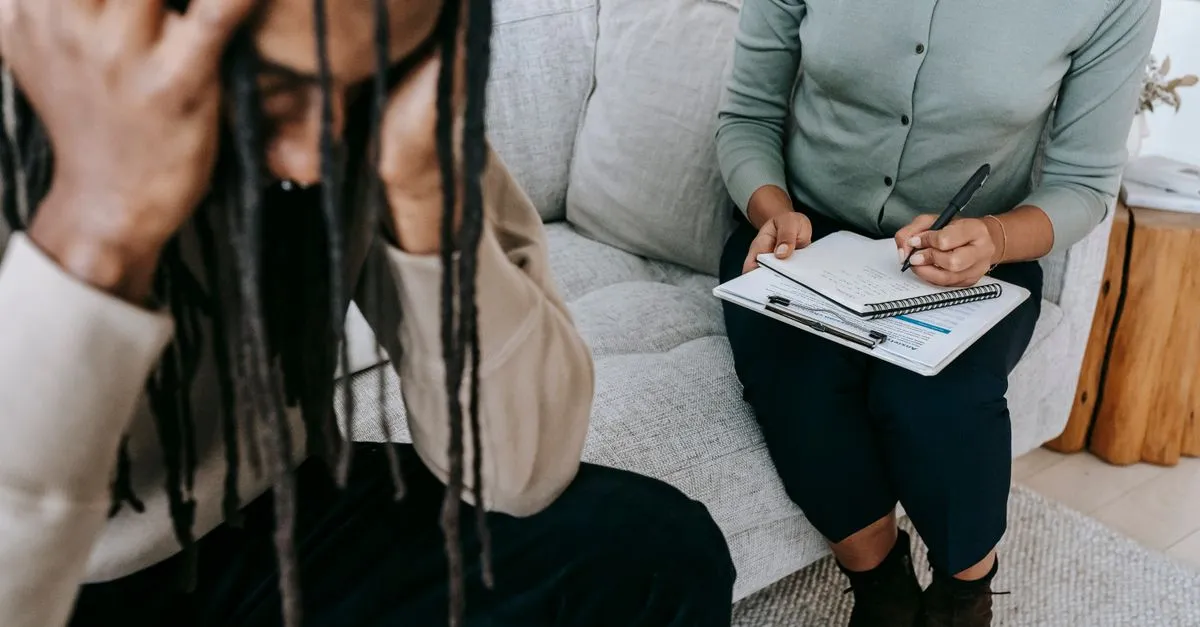 A client and a counselor during a therapy session, the kind of local practice that wins therapist near me searches in the map pack.