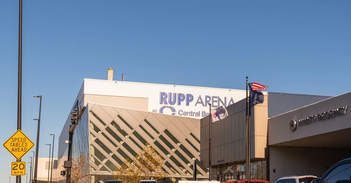 Daytime exterior view of Rupp Arena at Central Bank Center and the Hyatt Regency in downtown Lexington, Kentucky, under a clear blue sky.