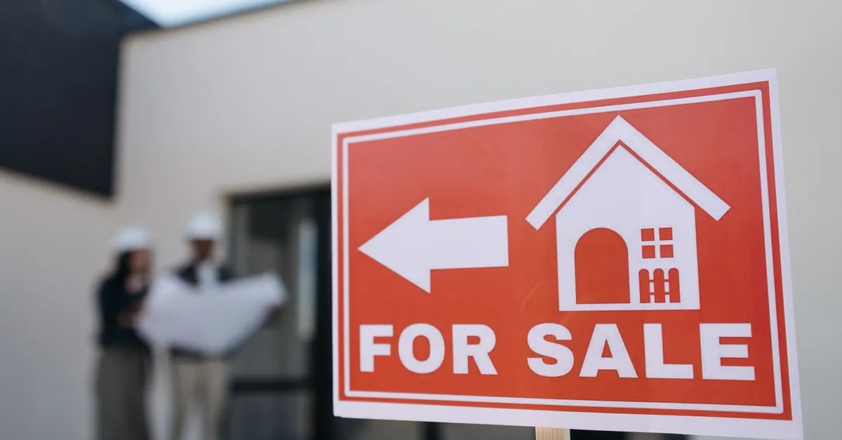 A red for sale sign outside a house on the market, the kind of listing local SEO helps buyers find.