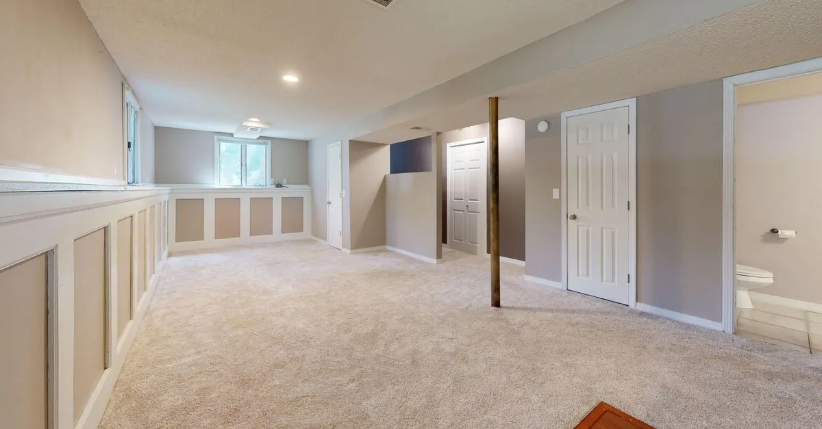 A bright finished basement remodel with carpet and recessed lighting, the kind of before-and-after transformation a remodeler showcases.