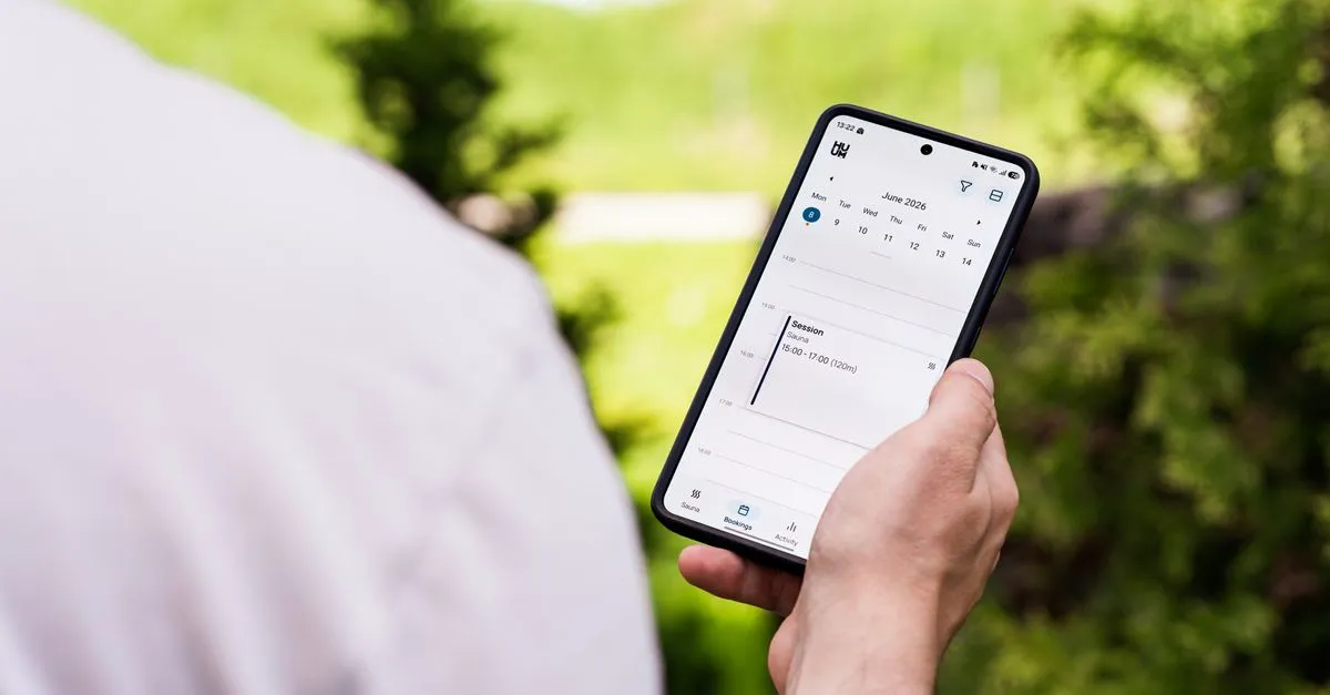 A person booking an appointment on their phone, the way most new patients want to schedule.
