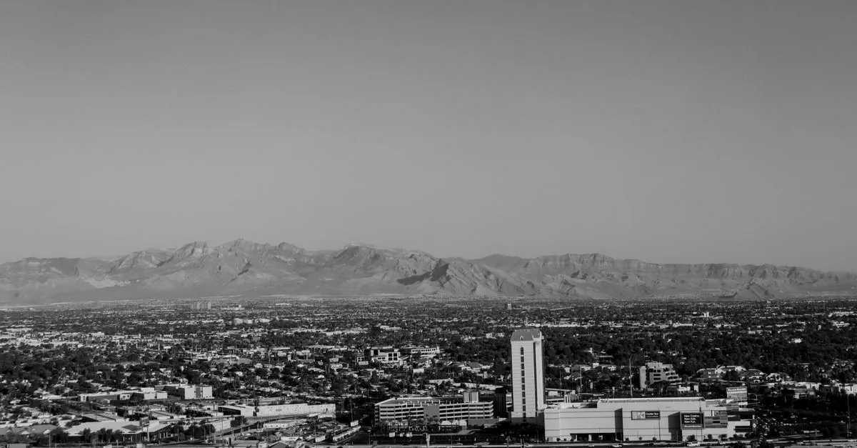 A black and white aerial view of the Las Vegas valley sprawling in low-rise neighborhoods out to the surrounding mountains, the residential market local SEO serves.
