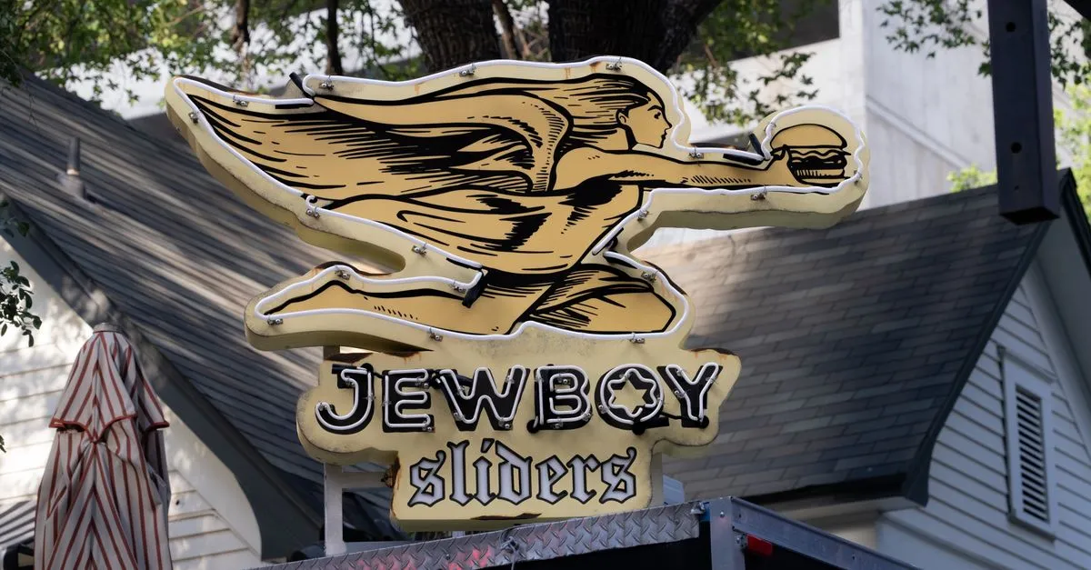 The neon Jewboy Sliders sign outside an independent Austin, Texas burger spot, the kind of local business that lives or dies in the map pack.