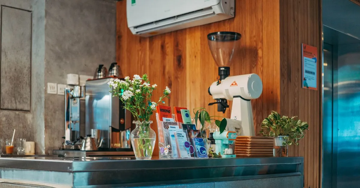 A modern Portland coffee shop interior with wooden decor and a stainless steel counter, the kind of local brand that needs a fast website.