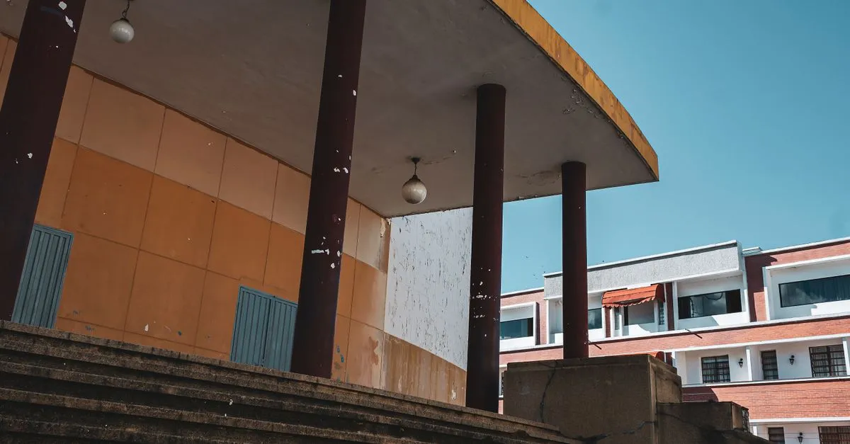The columned entrance and steps of a school building, the kind of campus a school website represents online.