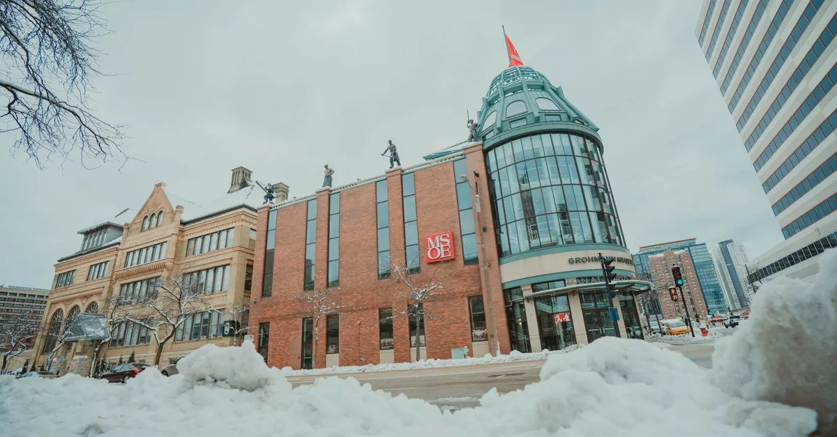 The Milwaukee School of Engineering and Grohmann Museum on a snowy downtown street, brick and glass buildings under a gray winter sky.