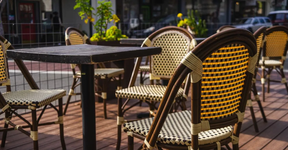 An empty outdoor cafe patio on a sunny Orlando street, the kind of neighborhood spot a local SEO ranking is decided on.