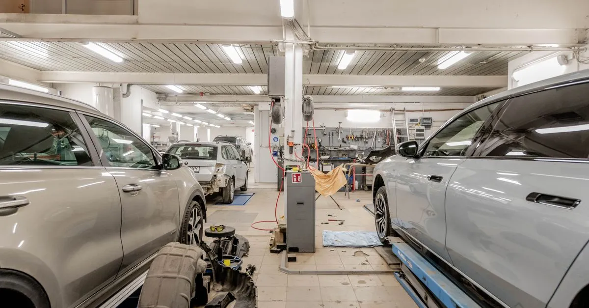 The interior of a busy auto repair shop with cars in the service bays, the kind of local shop that wins near me searches.