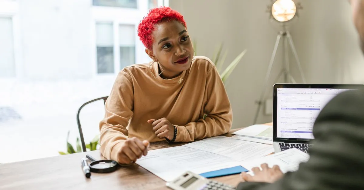 A consultant meeting a client across a table to discuss their business.