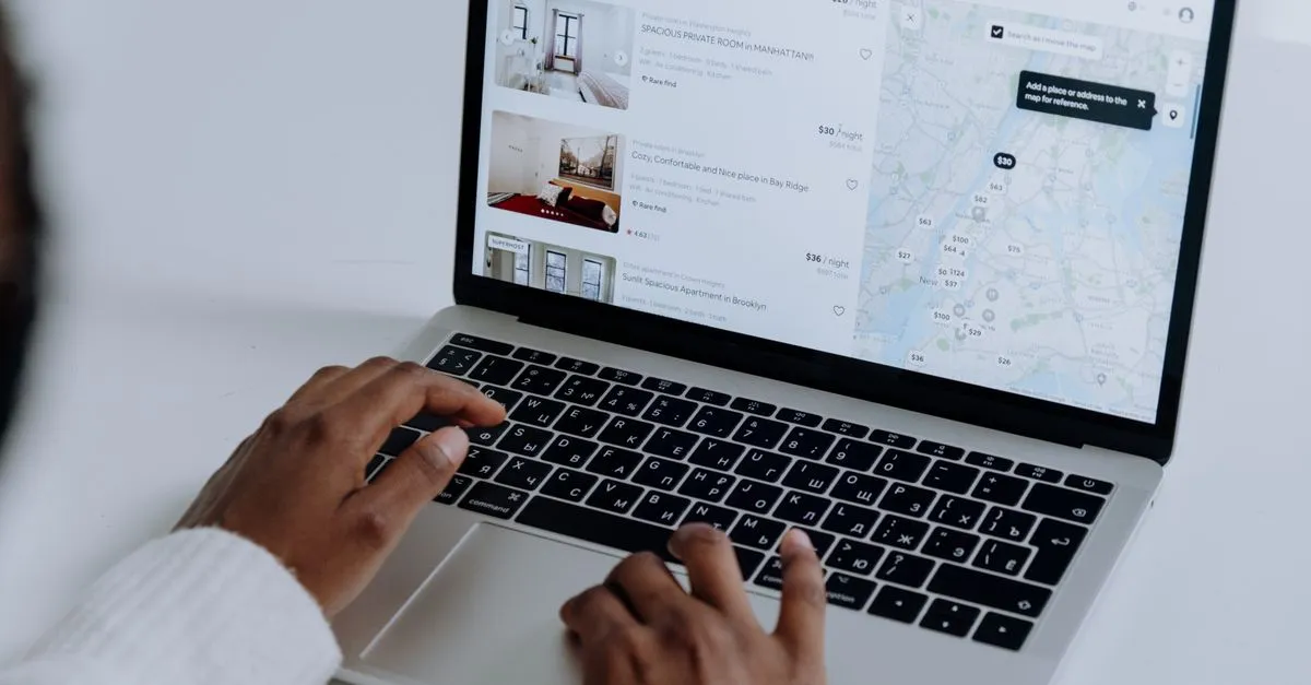 A home shopper browsing property listings on a laptop, the way most buyers start their search for an agent.