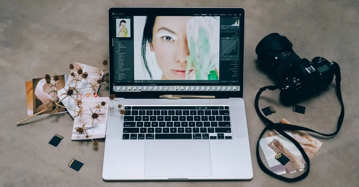 A photography portfolio open on a laptop beside a camera, the kind of galleries a photographer website has to load fast.