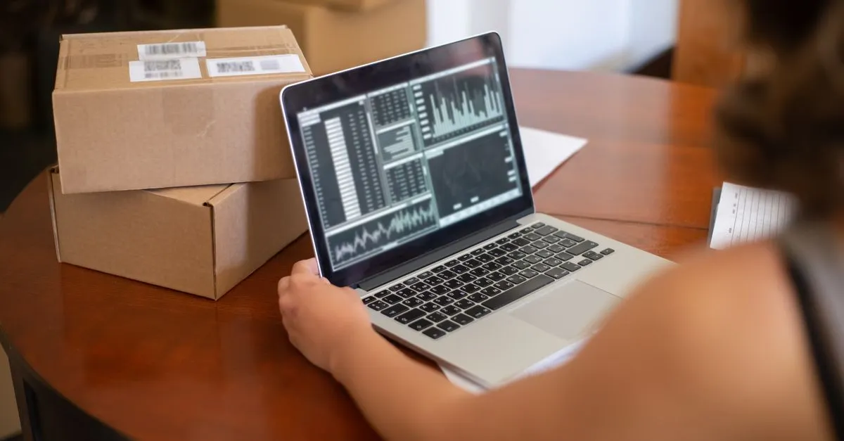 A small business owner reviewing website analytics charts on a laptop.