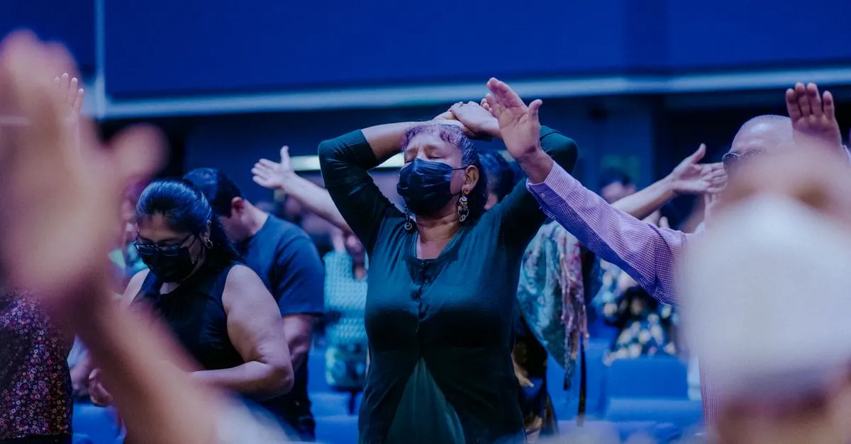 A congregation gathered together in prayer during a church service.