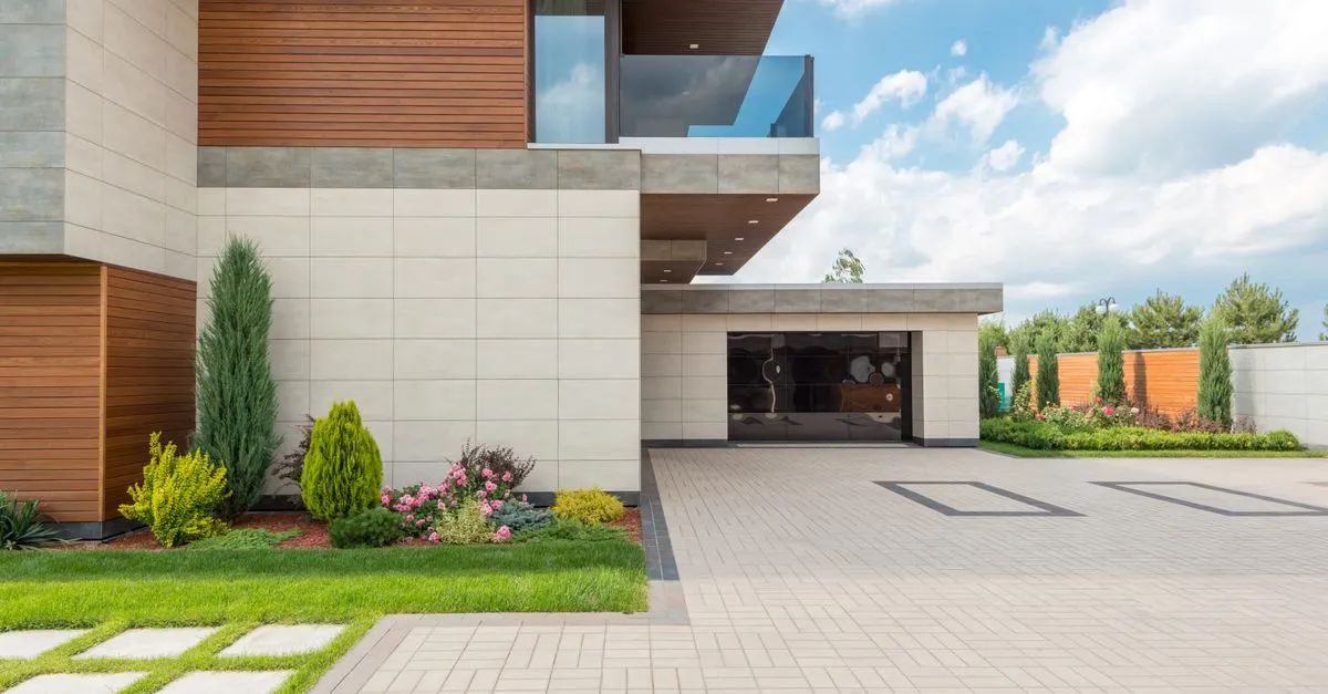 A finished concrete driveway leading to a modern home, the kind of flatwork a concrete contractor pours.