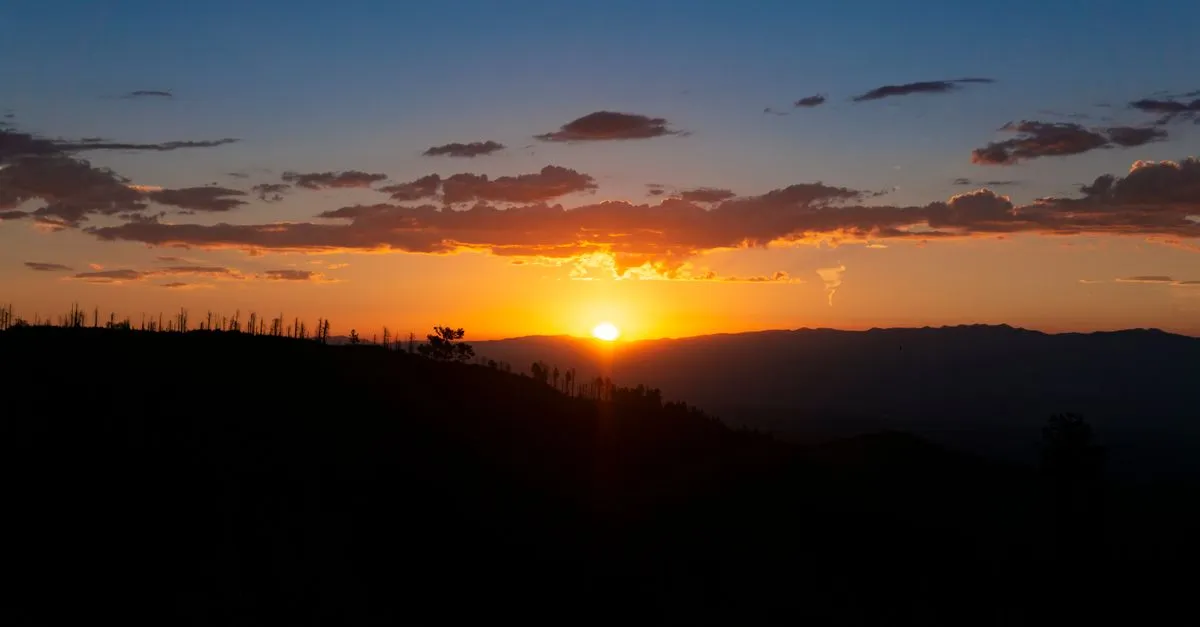 The sun setting behind a New Mexico mountain range, the high-desert landscape that surrounds Albuquerque.