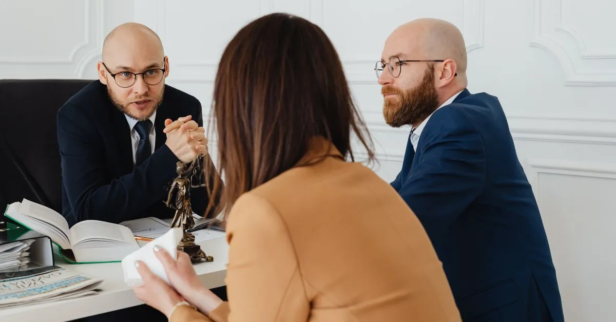 A lawyer meeting with a client across a desk in a local law office, the kind of consultation that starts with a near me search.