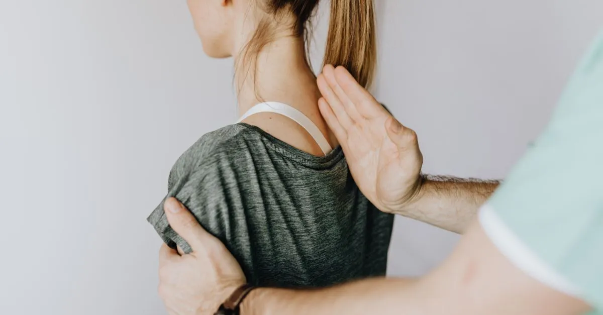 A chiropractor examining a patient&rsquo;s neck and upper spine, the kind of condition-specific care organic SEO for chiropractors builds pages around.