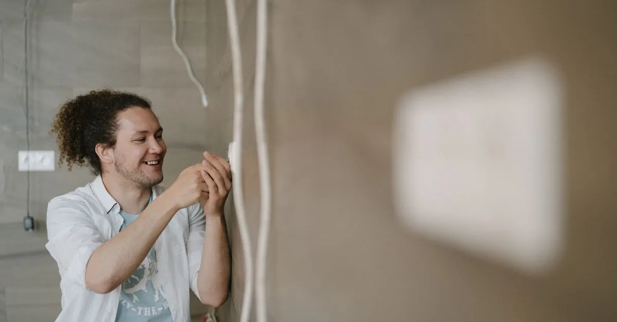 An electrician adjusts an outlet indoors, the kind of everyday job the searches behind electrician SEO lead to.