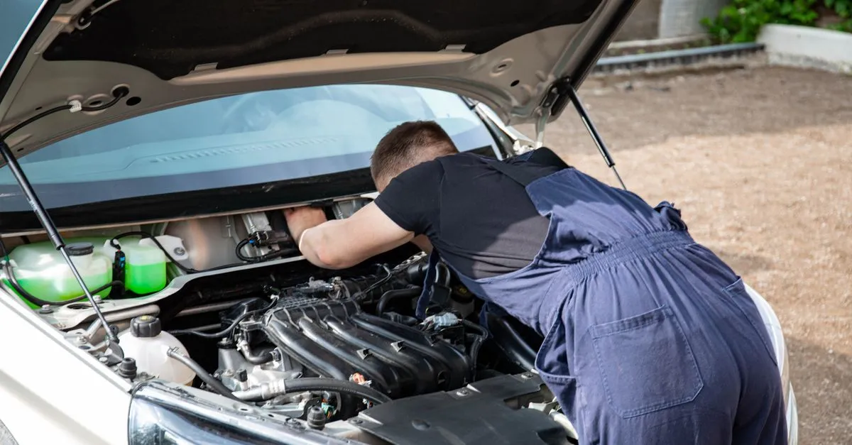 A mechanic repairing a car, one of the local service businesses that competes for the Phoenix map pack.