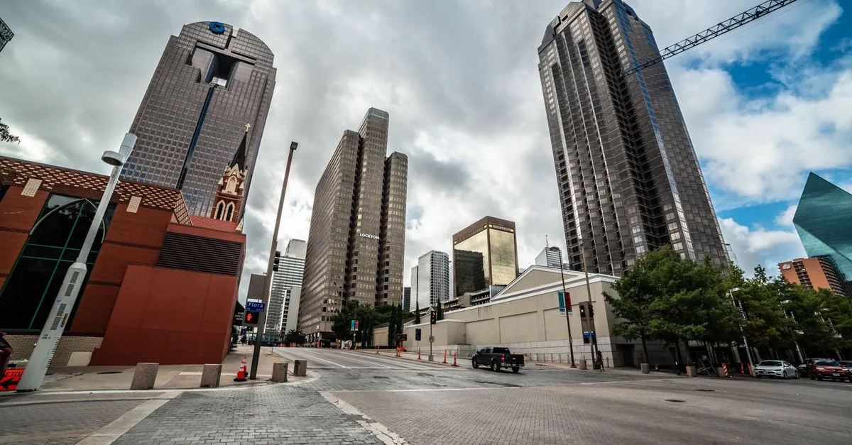 A downtown Dallas street corner in the Arts District with high-rise towers and a brick church, the kind of local market local SEO is built for.