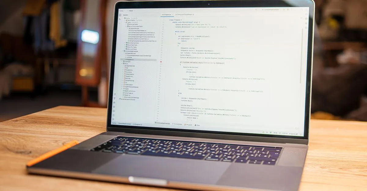 A laptop on a wooden desk showing lines of source code in a quiet workspace lit by daylight.