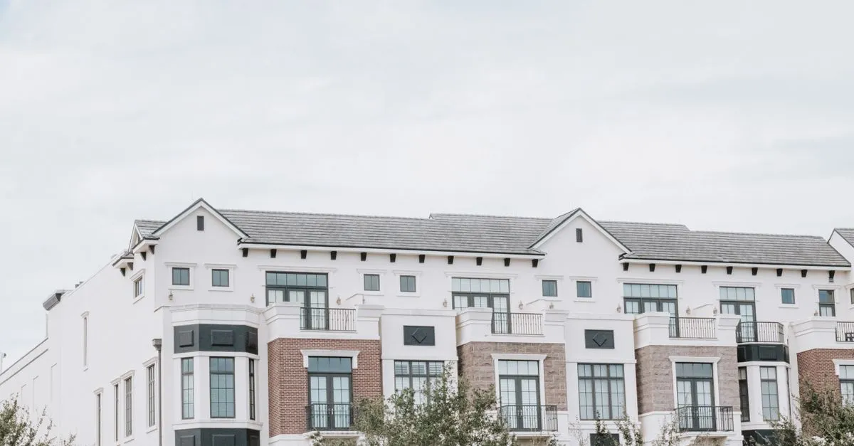 The exterior of a modern apartment building, the kind of rental a property management company keeps leased through search.