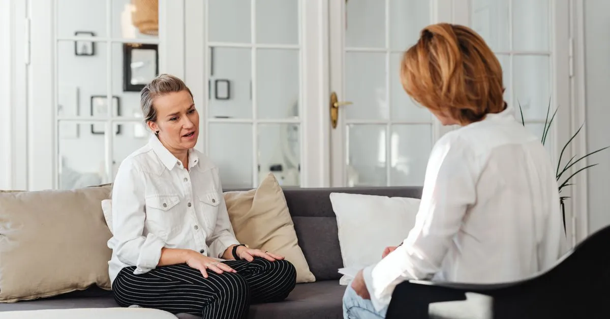 A counselor and client talking one on one during an addiction treatment counseling session.