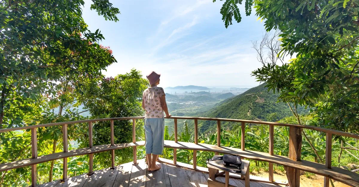 A traveler taking in a scenic viewpoint on a guided tour, the moment that turns a search into a booking.