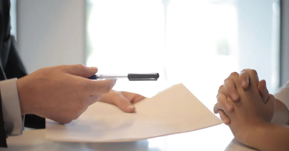 A new member signing loan paperwork at a credit union branch after finding it through search.