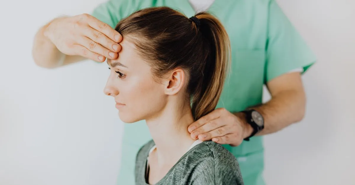 A chiropractor treating a patient&rsquo;s neck and upper spine in a clinic, the kind of care a chiropractic website is built to explain.