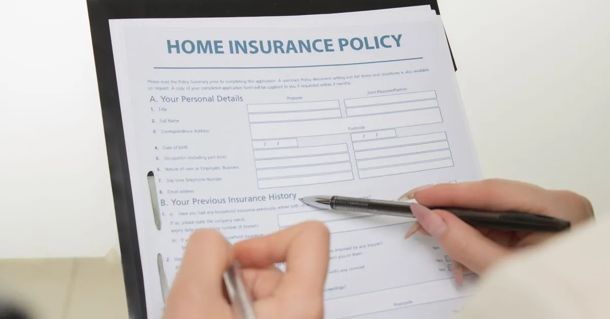 A client filling out a home insurance policy application in an agent office, the kind of local agency that wins near me searches.