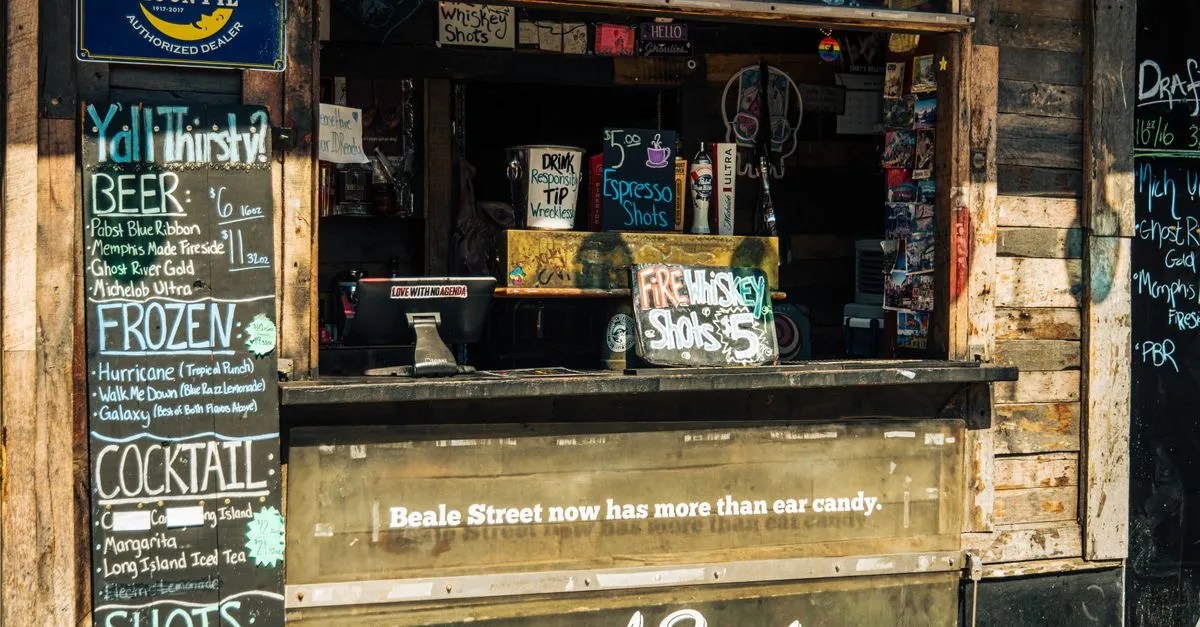A weathered wooden walk-up bar on Beale Street in Memphis, its chalkboard menus listing local beers and cocktails beneath a sign reading Beale Street now has more than ear candy.