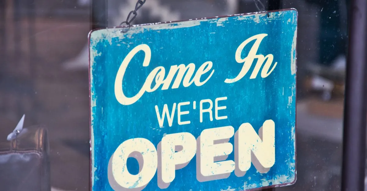 Retro blue open sign on a shop door, representing a local business earning its knowledge panel.