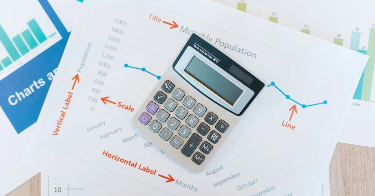A calculator on financial charts, standing in for reading real SEO performance data.
