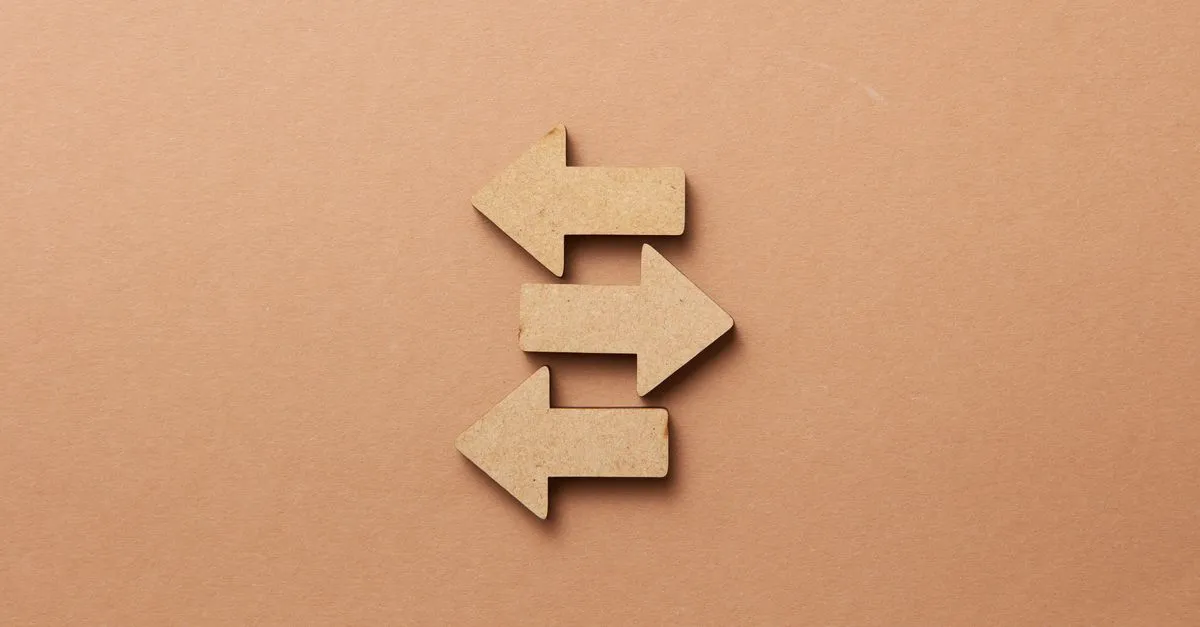 Opposite wooden arrows, standing in for choosing between SEO, AEO, and GEO.