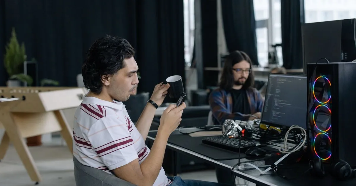 Two developers reviewing code during a website audit.