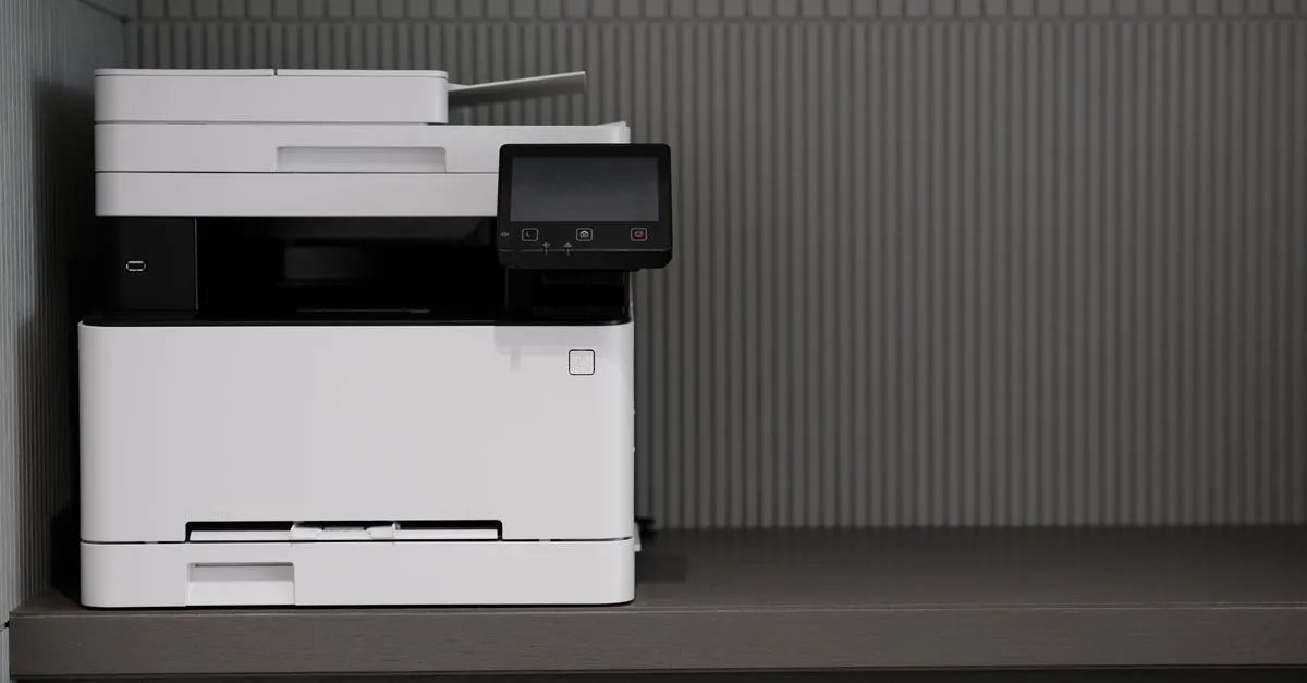 A sleek, modern printer situated on a minimalist office desk with a textured background.