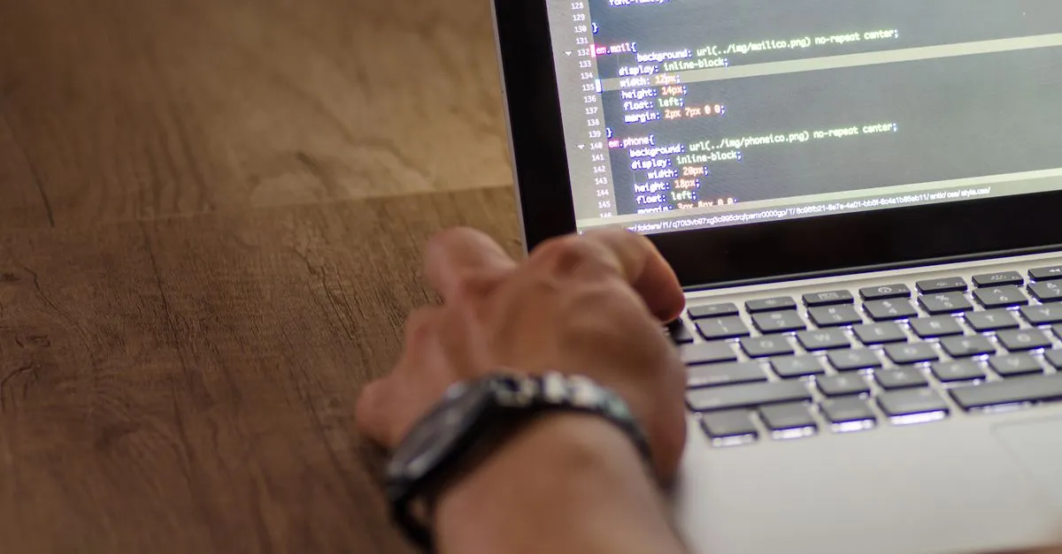 A close view of a hand at a laptop keyboard with website code on the screen, in a clean workspace.