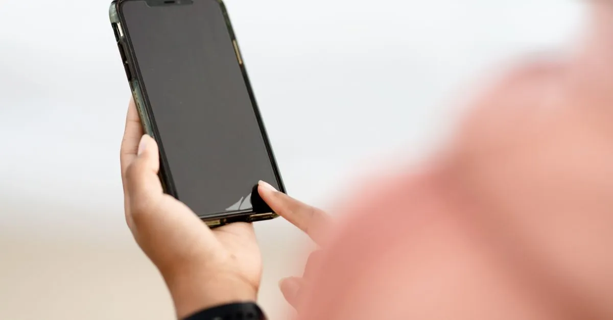 A person flagging a bad Google review for removal on a smartphone.