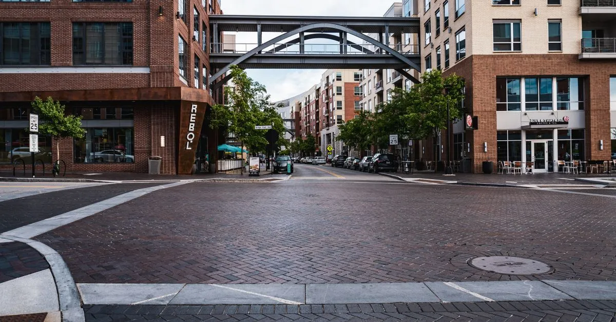 A brick-paved street in the Bridge Park district of Dublin in the Columbus metro, lined with new mixed-use buildings and local shops.
