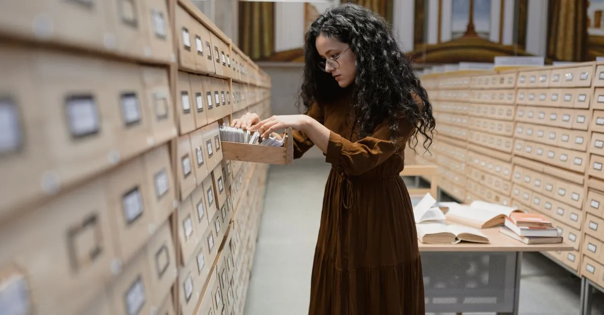 A researcher browsing a library card catalog drawer, standing in for how Google indexes pages.