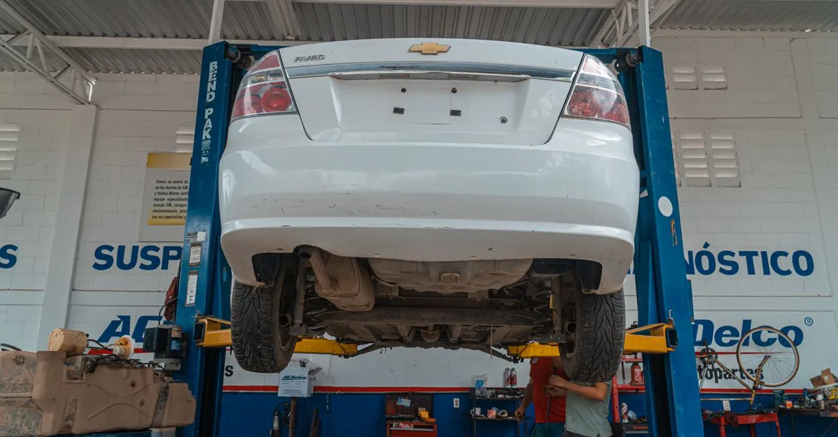 A car raised on a lift in an independent auto repair shop, the kind of local shop drivers find when they search for a mechanic near me.