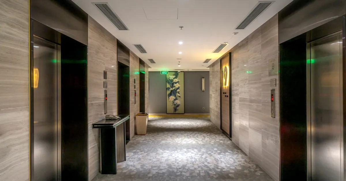 A modern hotel hallway with elevators and contemporary decor, the kind of property local seo for hotels helps travelers find.