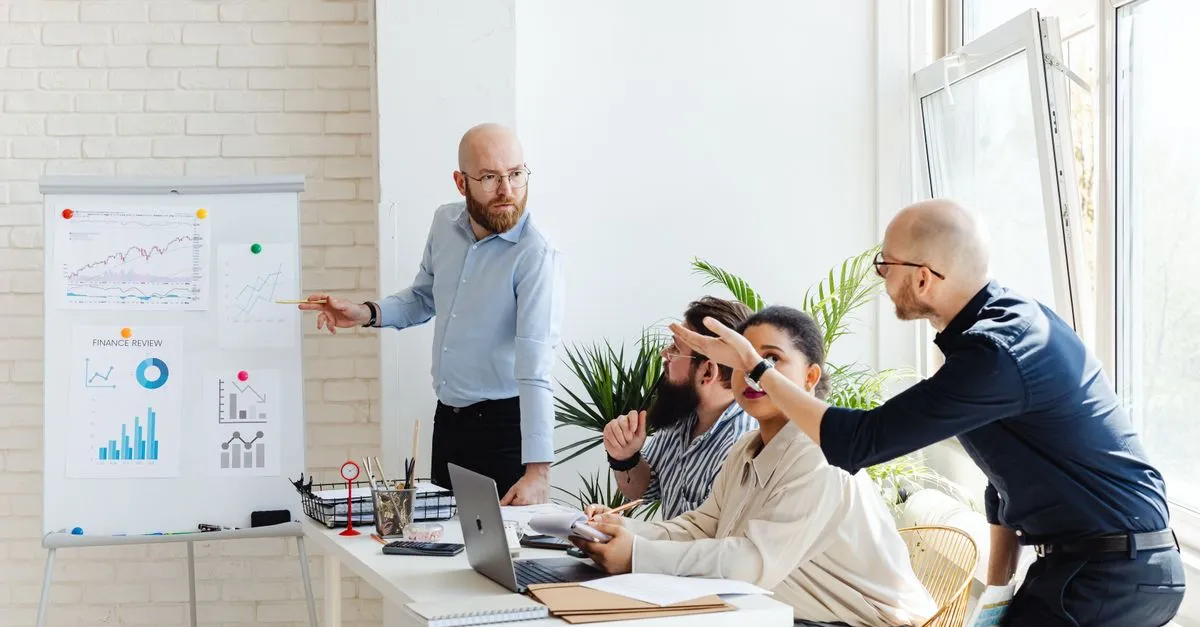 A business consultant presenting strategy to a team in a modern office.