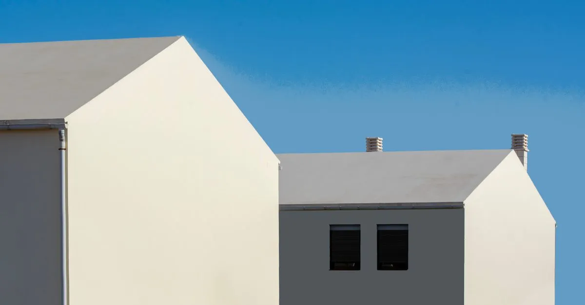 Two clean modern homes against a blue sky, the kind of listing real estate SEO helps buyers find in organic search.
