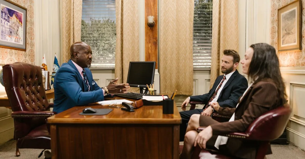 Lawyers meeting with a client in a professional office, the kind of firm SEO for lawyers helps get found.