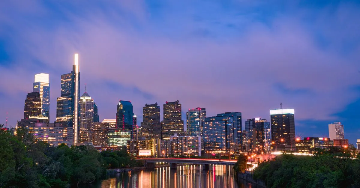 The Philadelphia skyline at twilight reflected on the Schuylkill River, the dense walkable market where the map pack is won.