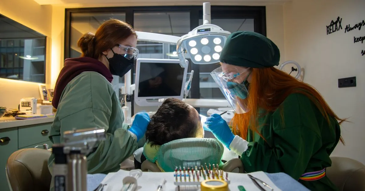 Dentists treating a patient at a clinic, the kind of practice SEO for dentists helps get found.